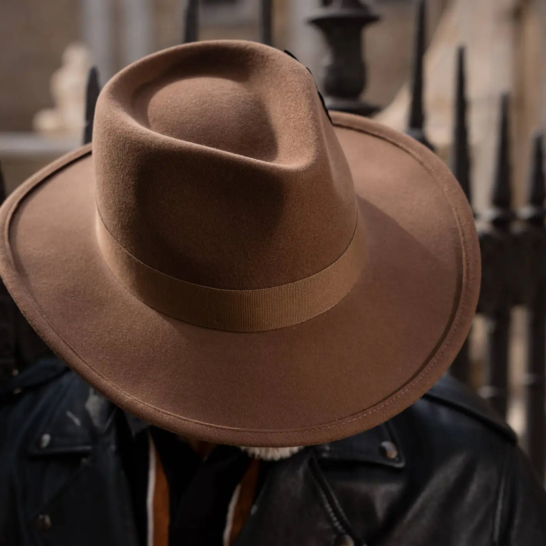 cappello australiano in feltro di morbido cashmere color castoro primario nesti con giacca di pelle nera e atmosfera urban gotica