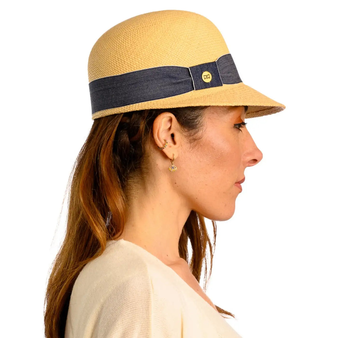 primo piano laterale di donna adulta con capelli lunghi che indossa un cappello di panama con visiera corta color naturale realizzato da cappelleria primario nesti